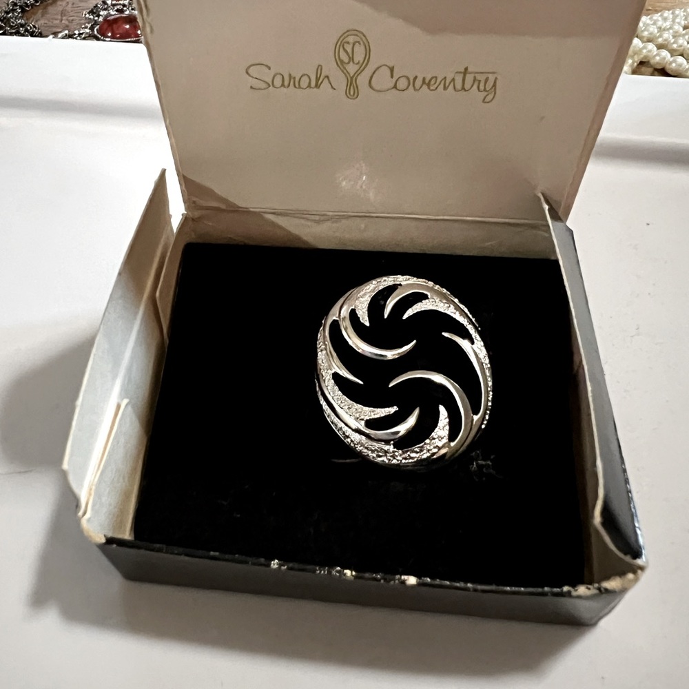 Vintage mint condition Sarah Coventry Carosel brooch in original package.